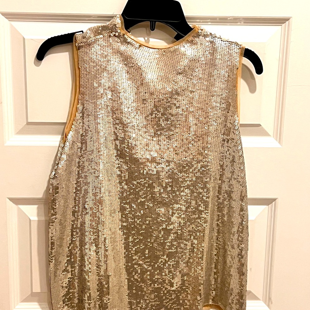 A fun silver sequin with lining tank top. Button enclosure in the back.
